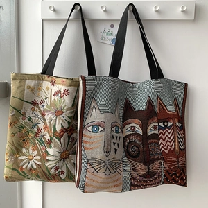 Detail of floral daisy and abstract cat printed canvas tote bags with zipper closure
