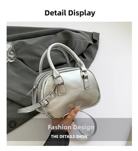 Detail of silver metallic Boston bag showing wrinkled leather texture and dual handles