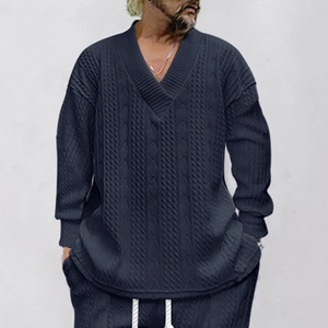 Detailed view of men's V-neck knit sweater featuring classic navy blue cable knit texture