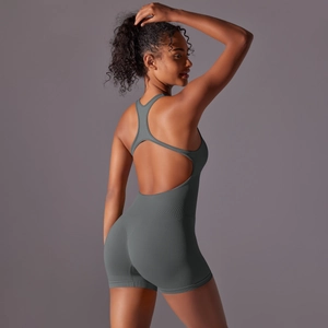 Close-up of seamless dark grey yoga romper showing cross-back design and breathable texture