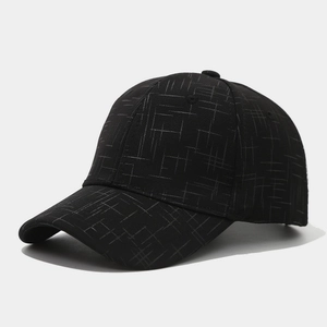Close-up of black baseball cap with fine white grid texture and curved brim detail