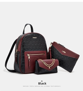 Three-piece black and red embossed leather backpack set with golden hardware details