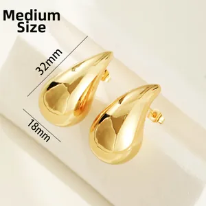 Detailed macro view of medium-sized hollow waterdrop stud earrings with 32mm height
