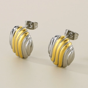 Detailed shot of gold and silver mixed color earrings with unique pleated wavy texture