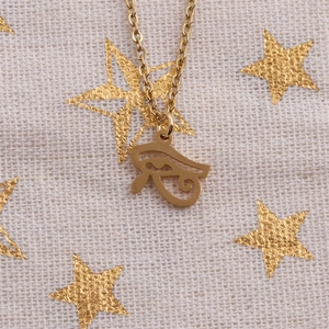 Golden stainless steel necklace featuring a Turkish evil eye pendant on beige star fabric