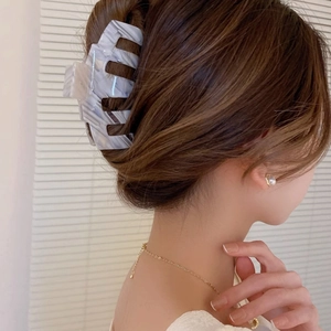 Elegant marble pattern acetate hair claw clip shown on model for a stylish look
