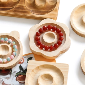 Macro view of wooden jewelry design tray with flower and bear shapes for DIY bead display