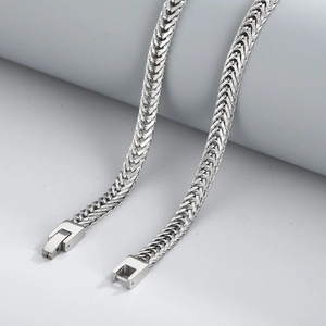 Hip hop silver stainless steel curb chain necklace with a square buckle clasp on a grey stand