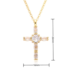 Detailed view of gold cross pendant with crystal micro-pave measuring 26mm by 16mm
