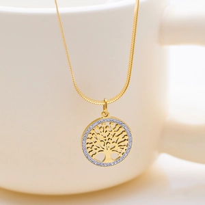 Golden tree of life necklace with pavé zircon pendant on elegant white ceramic