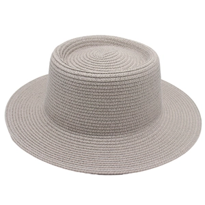Detailed view of the fine woven texture and flat top of this grey straw sun hat