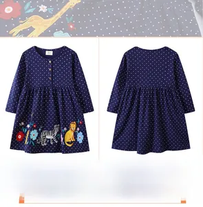 Close-up of girls' navy polka dot dress featuring detailed animal and floral embroidery