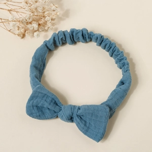 Detailed texture of light blue cotton linen baby headband with soft elastic bow design