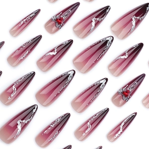 Long stiletto press-on nails with dark red gradient, silver fluid lines and red rhinestones
