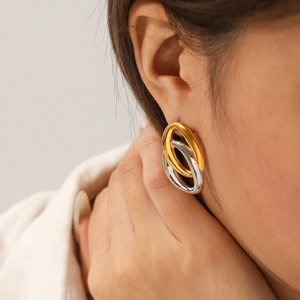 Two-tone interlocking hoop earrings in gold and silver stainless steel for women