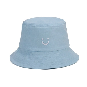 Close-up of smile embroidery on light blue cotton bucket hat for sun protection