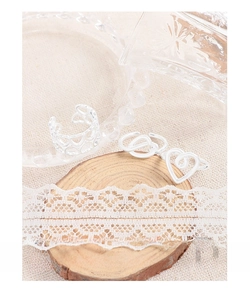 Detailed view of S925 sterling silver hollow heart rings on a rustic wooden slice