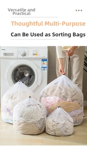 Set of four drawstring mesh laundry bags in different sizes on a light wooden floor