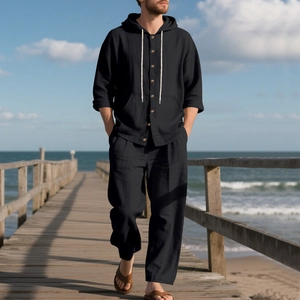 Close-up of black linen hooded button-down shirt texture and loose beach pants set