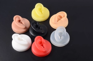 Detailed top view of multi-colored silicone ear models for piercing practice and jewelry display
