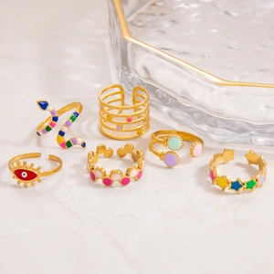 Set of 6 gold rings with colorful enamel details featuring evil eye and snake designs