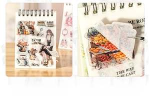 Detailed view of die-cut career stickers and tweezers on a vintage stationery notebook