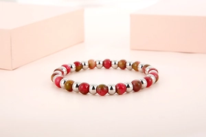 Detailed shot of red marble beads and silver spacers on minimalist beaded bracelet