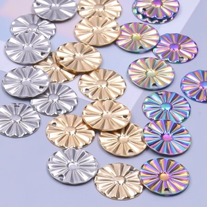 Vue macro de pendentifs ronds en métal texturé en or, argent et placage arc-en-ciel
