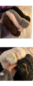 Detail of plush fuzzy headbands in various colors featuring colorful letter embroidery