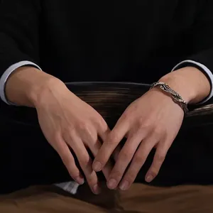 Handcrafted vintage twisted silver bangle for men featuring a textured woven design