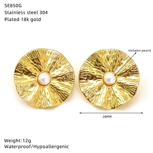 Detail of 18k gold plated stainless steel earring with ruffled metal and pearl inlay