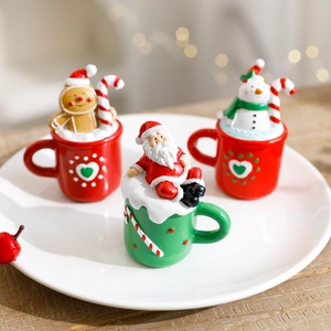 Miniature Christmas resin figurines with Santa, snowman and gingerbread man in tea cups