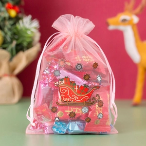 Pink organza drawstring gift bag with Christmas sleigh and snowflake prints for candies