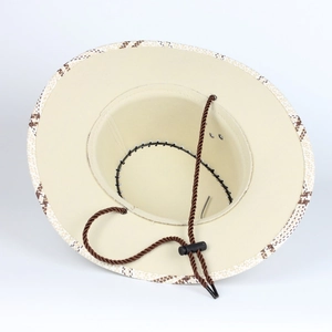Detail of straw cowboy hat interior with checkered brim and adjustable chin strap