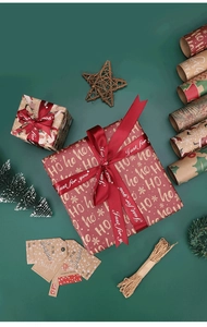 Flat lay of vintage Christmas wrapping paper set with red ribbons and festive tags
