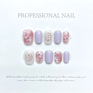Faux ongles faits main avec motifs floraux violets et dessins de fleurs de cerisier