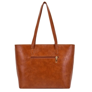 Detailed view of the brown synthetic leather texture and metallic zipper on this tote bag