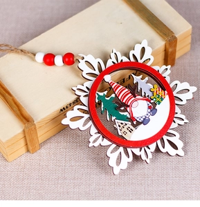 Detail of wooden gnome snowflake ornament with layered carvings and festive paint
