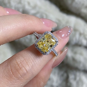 Macro shot of S925 silver halo ring with radiant cut yellow gemstone and pave stones