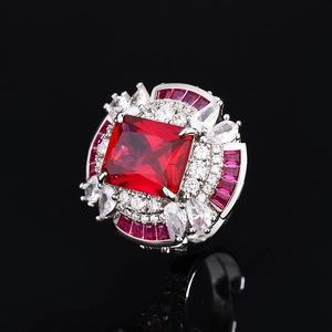 Elegant silver ring with a large square red gemstone surrounded by sparkling crystals
