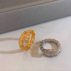 Close-up of gold and silver snake rings with sparkling cubic zirconia pavé detailing