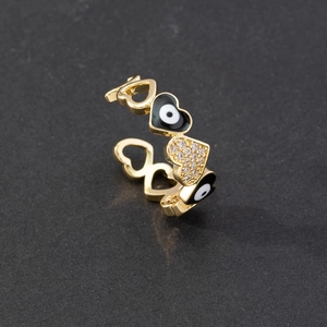 Detail of heart-shaped evil eye ring featuring white cubic zirconia and enamel finish