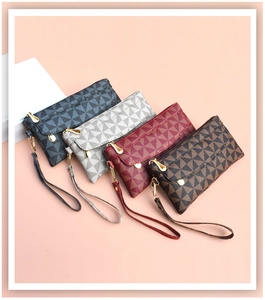 Detail view of colorful checkered PU leather wristlet bags with gold metal zippers