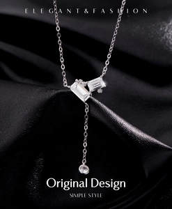 Elegant emerald-cut crystal Y-necklace on black silk background with silver tassel detail