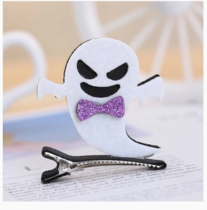 Detail shot of a white felt ghost hair clip with a purple glitter bow for Halloween party