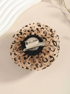 Detail of leopard print rose brooch with silver dual-use clip and pin fastener