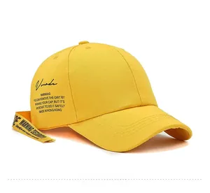 Detail of yellow canvas baseball cap with Vmade print and Warning graphic strap