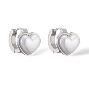 Macro detail of silver heart huggie earrings with white mother of pearl inlay