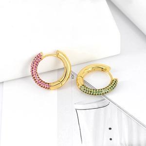 Macro shot of S925 silver hoop earrings with vibrant pink and green pave set zircons