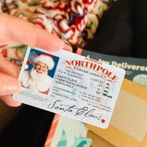 Detailed view of Santa Claus North Pole Driver Licence card held in hand as a kids gift
